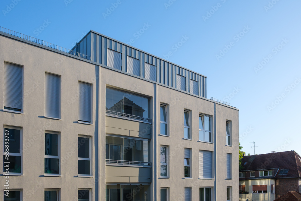 Facade of a modern apartment building against a blue sky