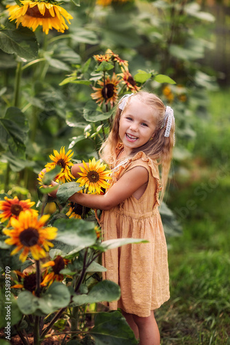 girl with a sunflower, summer in the village, August, vegetable garden