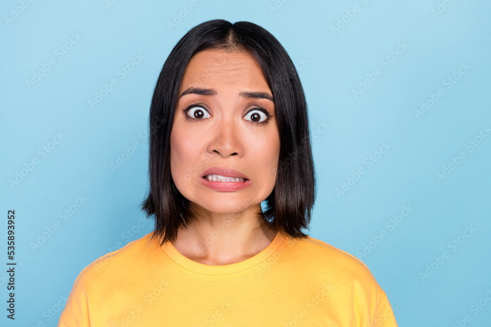 Portrait of nice pretty lovely girl with straight hairstyle dressed yellow t-shirt scared staring isolated on blue color background Portrait of nice pretty lovely girl with straight hairstyle dressed yellow t-shirt scared staring isolated on blue color background