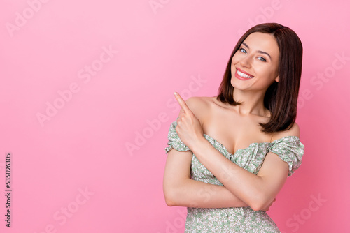 Photo of sweet dreamy lady wear green dress pointing finger empty space isolated pink color background