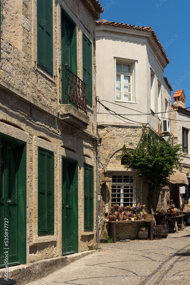 View of old, historical, traditional stone houses in famous, touristic Aegean town called Alacati. It is a village of Cesme, Turkey. It is a sunny summer day