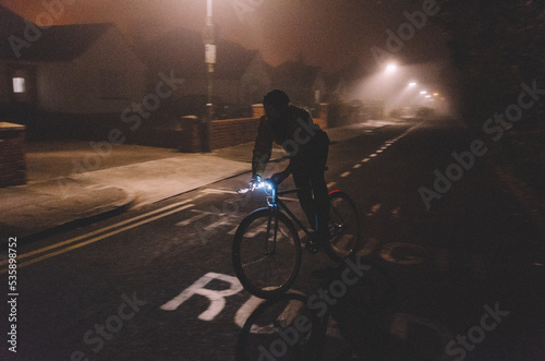 man cycling in fog
