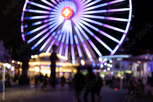 blurred silhouette of illuminated ferris wheel park