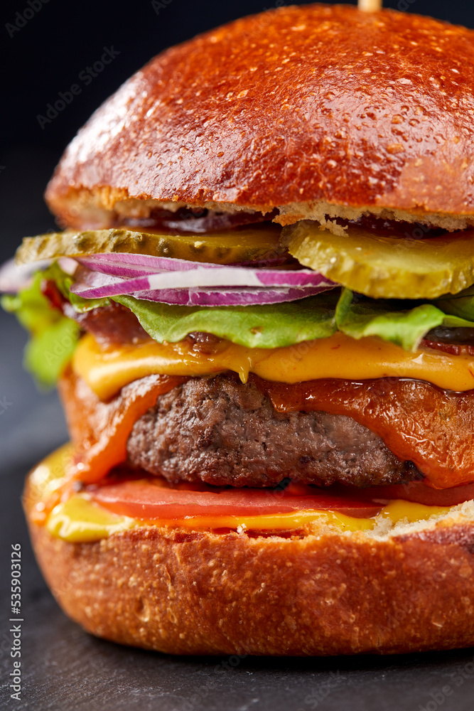 tasty burger with beef cutlet and vegetables