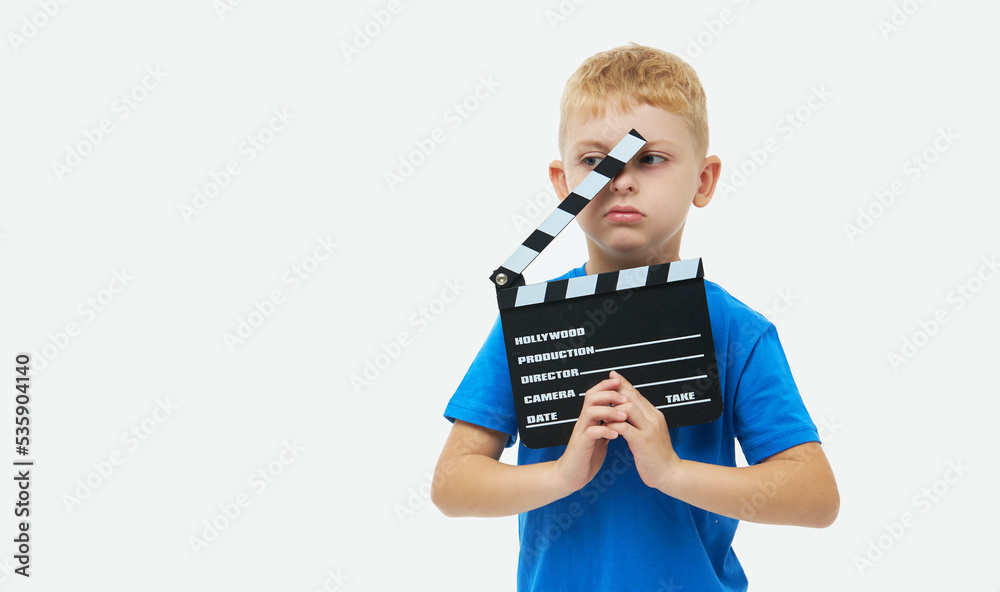 Funny smiling child boy hold film making clapperboard isolated on white background. Studio portrait. Childhood lifestyle concept. Copy space for text Funny smiling child boy hold film making clapperboard isolated on white background. Studio portrait. Childhood lifestyle concept. Copy space for text