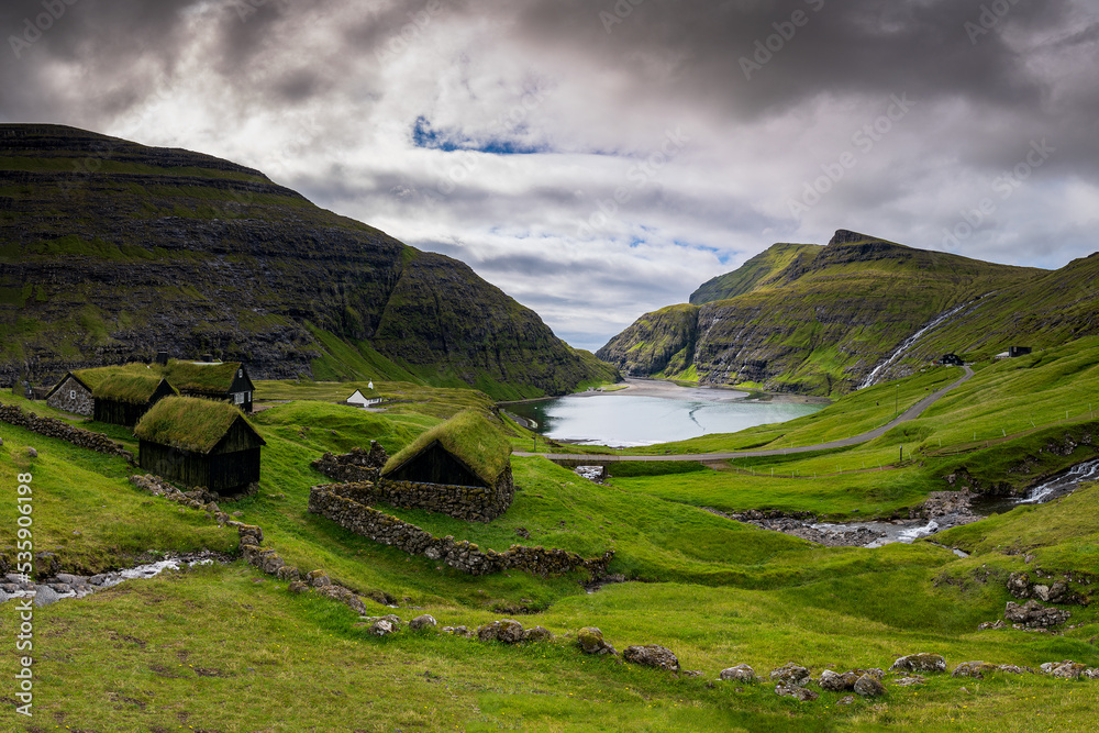 Saksun is a remote little village on Streymoy island in the wild Faroe Islands. The village is famous for its unique location placed above a jaw-dropping lagoon.