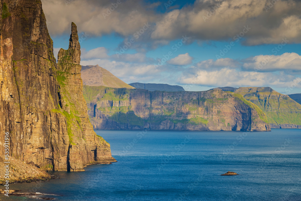 Trøllkonufingur, which means the witch's finger or troll woman's finger, is a 313 m tall monolith on the south-east side of the village Sandavágur in Faroe Islands.