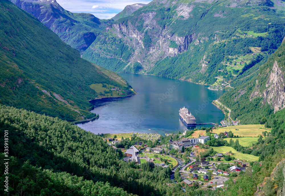 Panoramic view of Geiranger, a small tourist village at the head of the Geirangerfjord, where the Geirangelva river empties. Photo taken from Flydalsjuvet viewpoint.