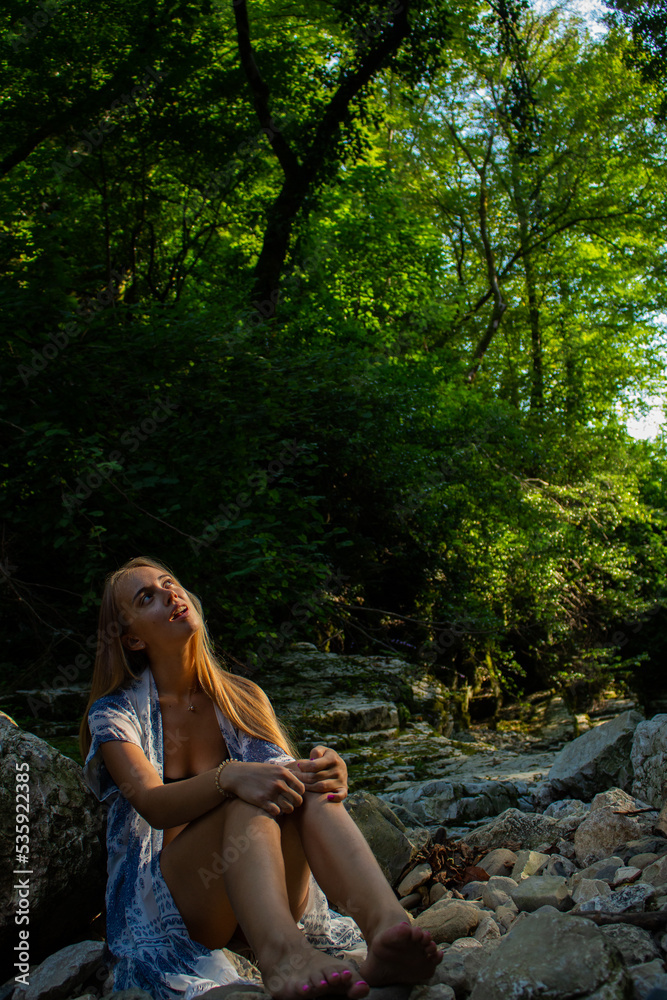 beautiful blonde in a swimsuit walks in the mountains beautiful blonde in a swimsuit walks in the mountains