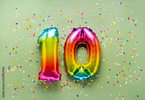 Colorful balloon number 10 on light green background. New Year of birthday concept