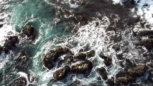 Bird's Eye View Over Caleta Chañaral de Aceituno Waves Splashing On Rock Formations In South Chile - drone shot photo