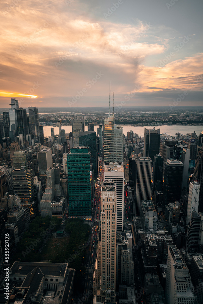 city at sunset in Manhattan New York views skyscraper streets urban buildings river sun sky clouds 