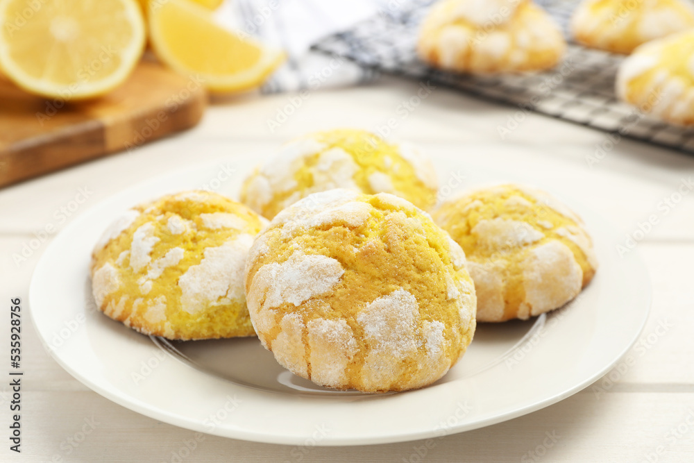 Tasty homemade lemon cookies on white wooden table