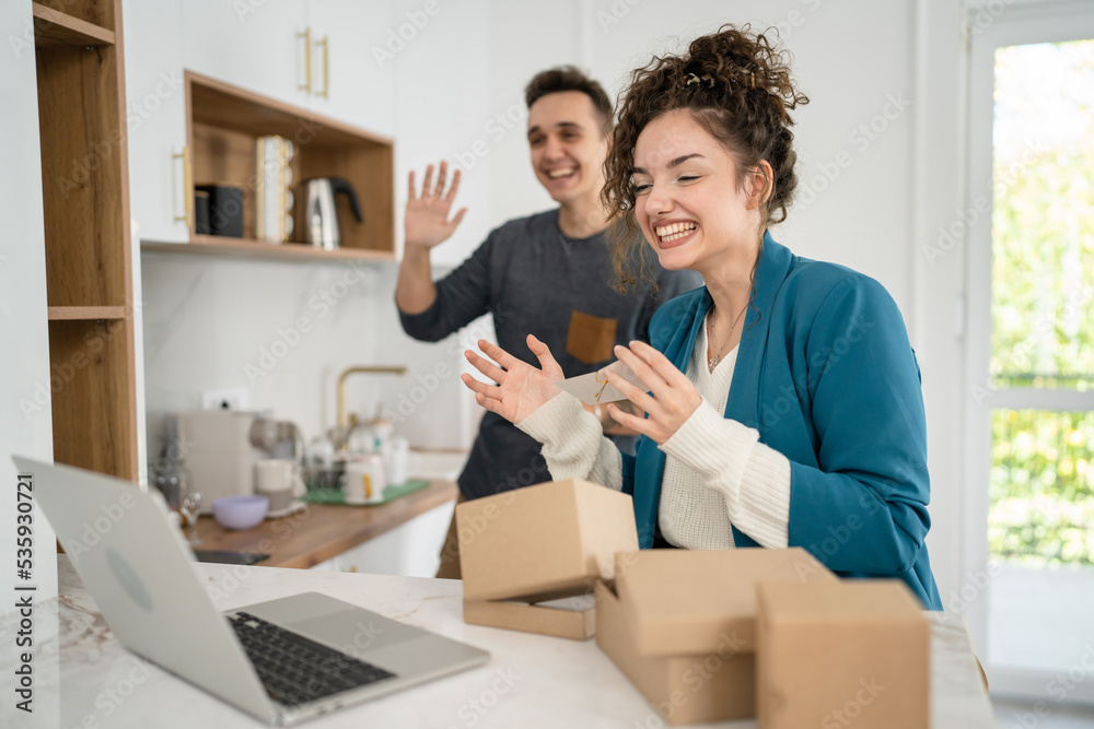 couple woman and man open presents and read card while on video call couple woman and man open presents and read card while on video call