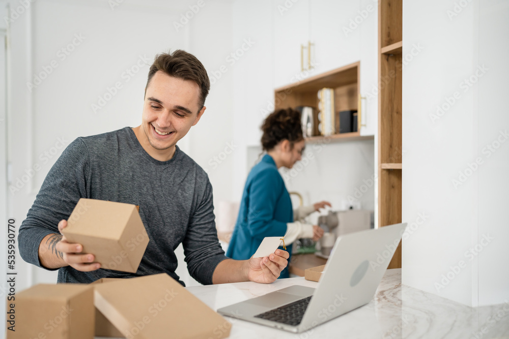couple woman and man open presents and read card while on video call
