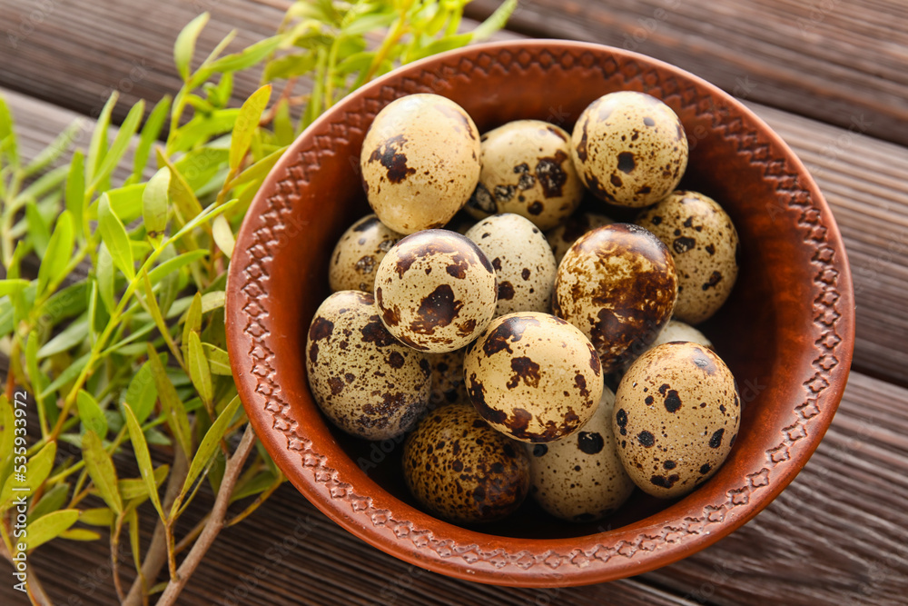 Bowl with fresh quail eggs on wooden background, closeup Bowl with fresh quail eggs on wooden background, closeup