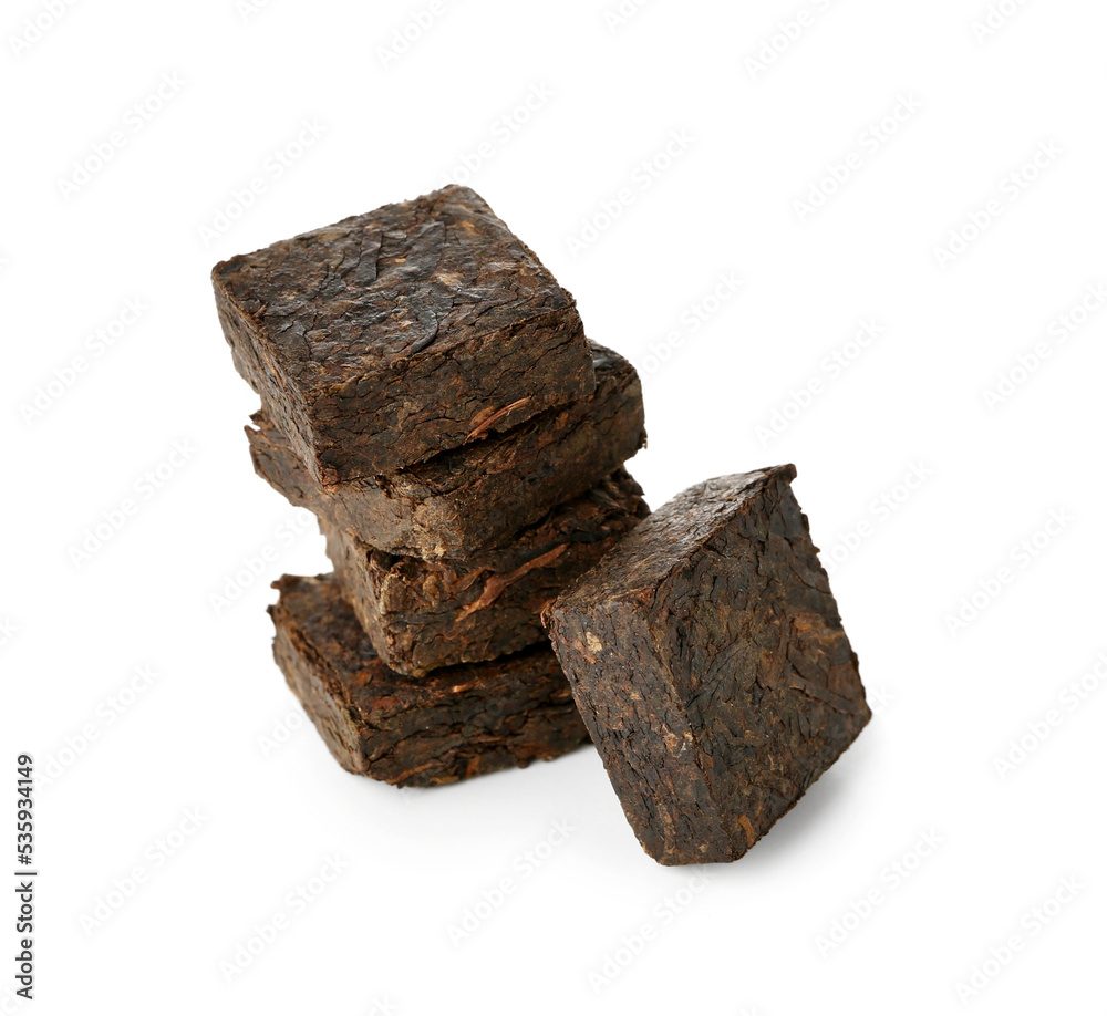 Stack of dry pressed puer tea on white background
