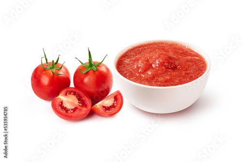 Tomato sauce in a bowl with fresh tomato isolated on white background.