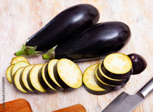 Organic eggplant on wooden cutting board. Healthy nutrition concept