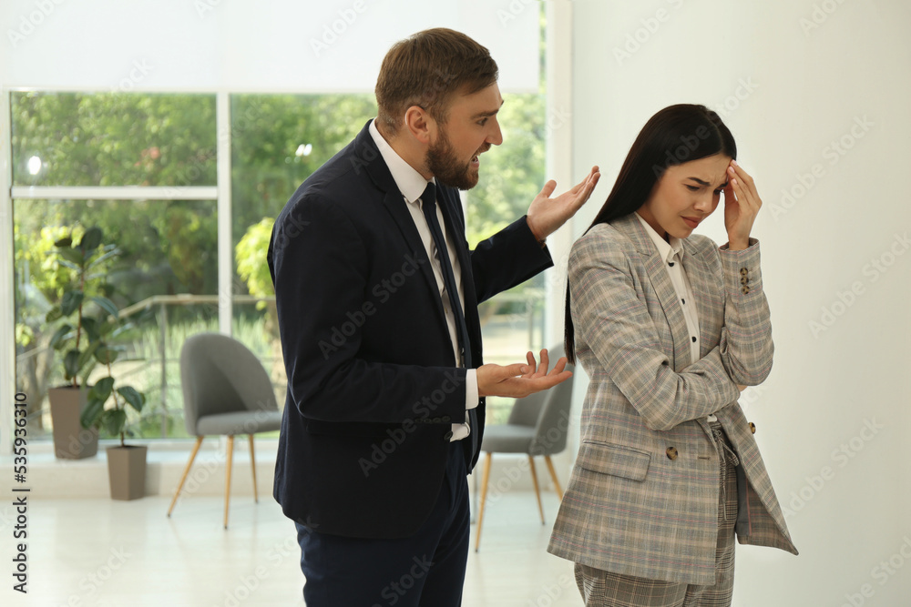 Man screaming at woman in office. Toxic work environment Man screaming at woman in office. Toxic work environment