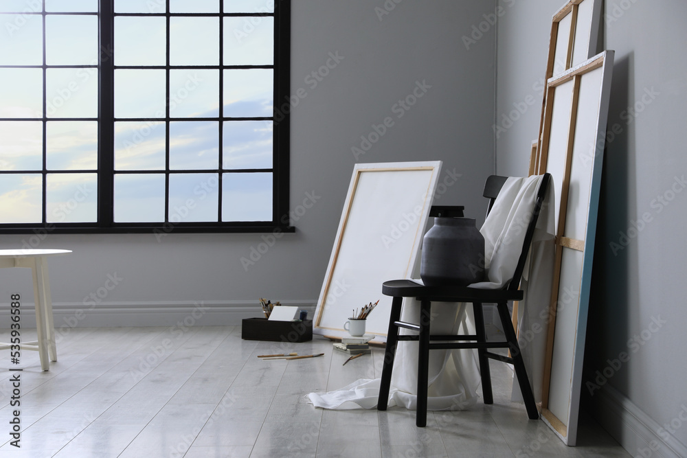 Stylish artist's studio interior with canvas and brushes Stylish artist's studio interior with canvas and brushes