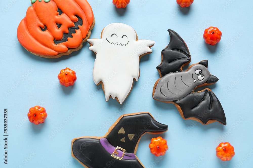 Halloween cookies with candies on blue background