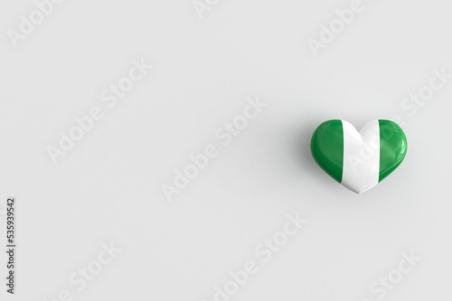 Love for Nigeria - heart shaped glossy icon with national flag of Nigeria. Souvenir of Nigeria as a symbol of pride in their country. 3D rendering, copy space