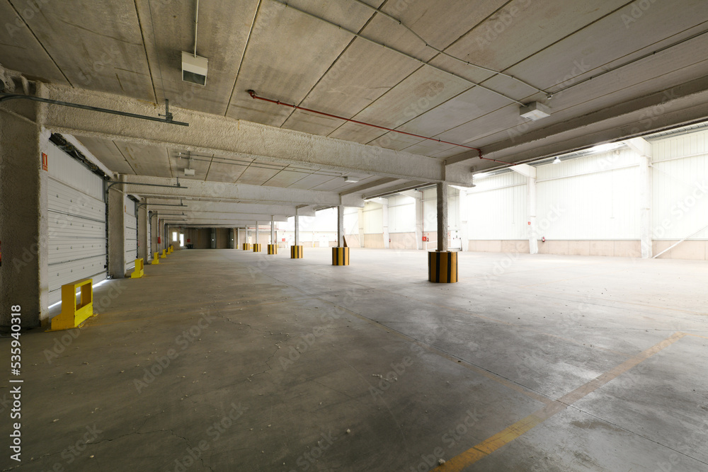Empty industrial building with concrete floors, precast concrete rib ...