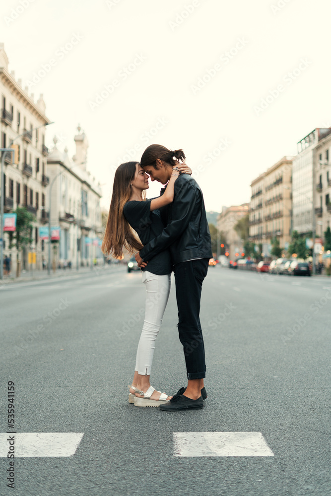 Edgy couple kissing each other in the street Edgy couple kissing each other in the street