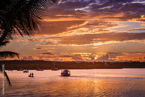 Idyllic Beach at sunset with palm trees and boats in Porto Seguro , BAHIA