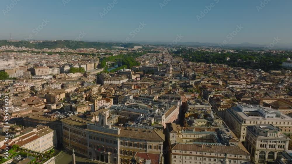Forwards fly above buildings in city centre. Historic town development lit by bright sunshine. Rome, Italy Forwards fly above buildings in city centre. Historic town development lit by bright sunshine. Rome, Italy