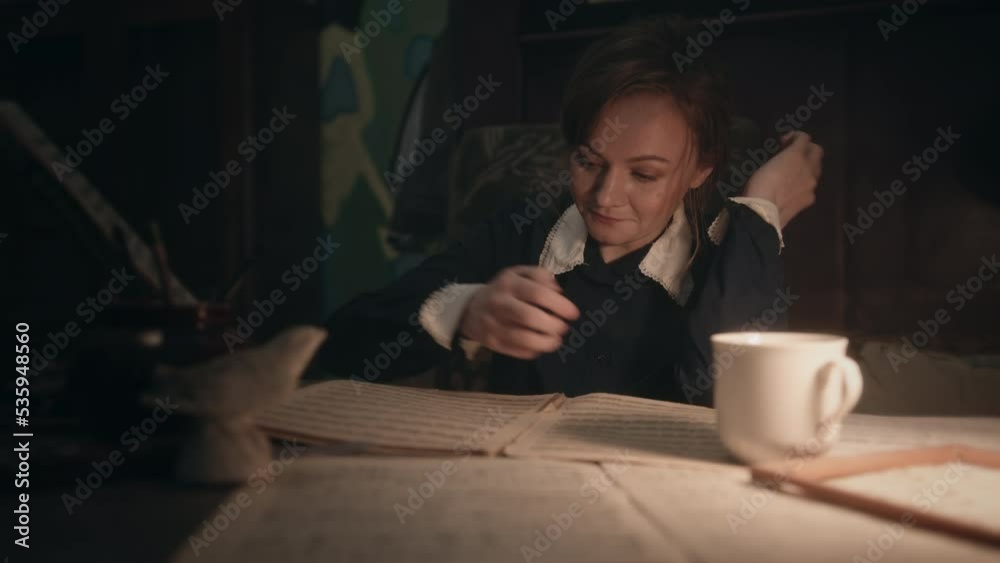 Musician reads sheet music thoughtfully and makes notes Musician reads sheet music thoughtfully and makes notes