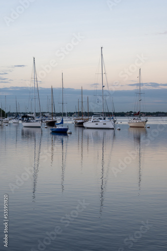 Sailboats in Dinner Key anchorage reflected in calm water of Biscayne Bay in Miami, Florida. © Francisco