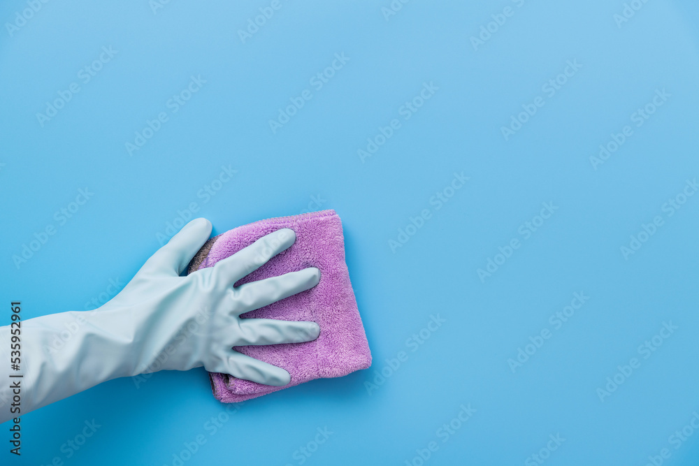 Hand clean with rag on blue background Hand clean with rag on blue background