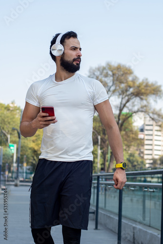 Young Athletic man listening to music after exercising 