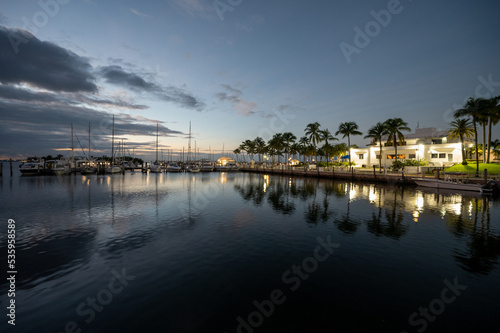 Miami City Hall and Dinner Key Marina in morning twilight on calm summer morning.