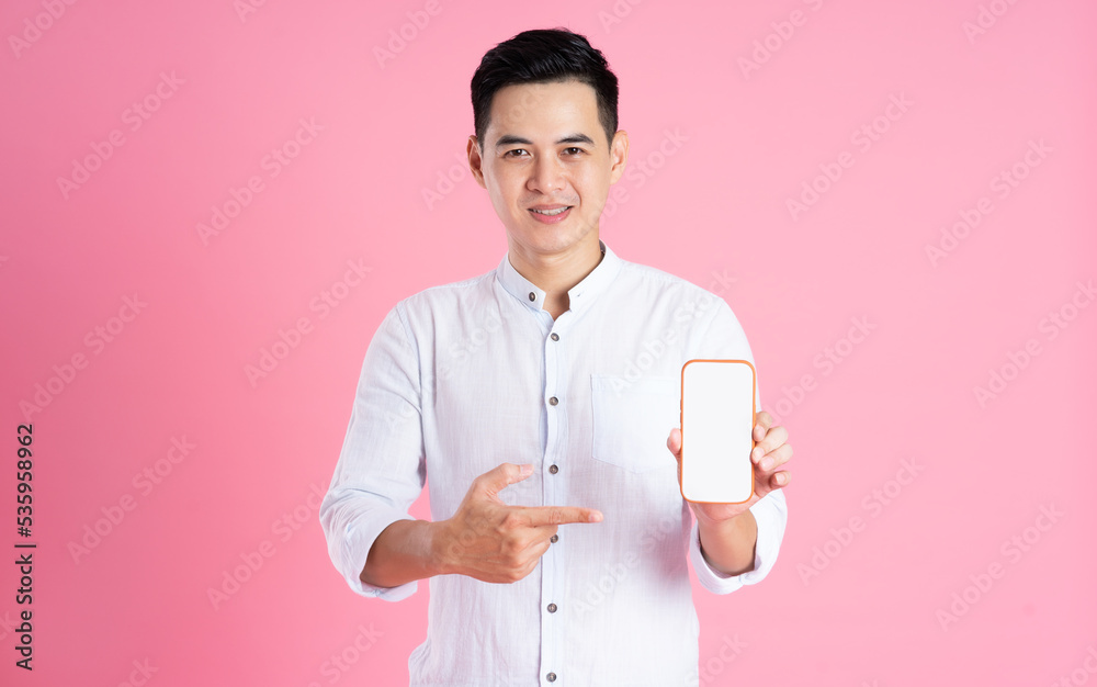 portrait of asian man posing on pink background portrait of asian man posing on pink background