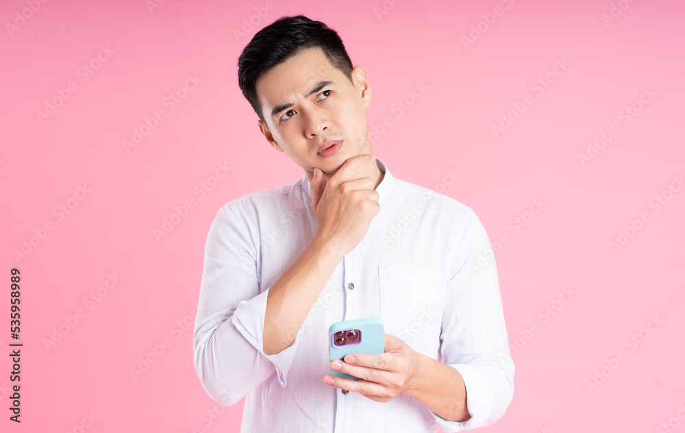 portrait of asian man posing on pink background portrait of asian man posing on pink background
