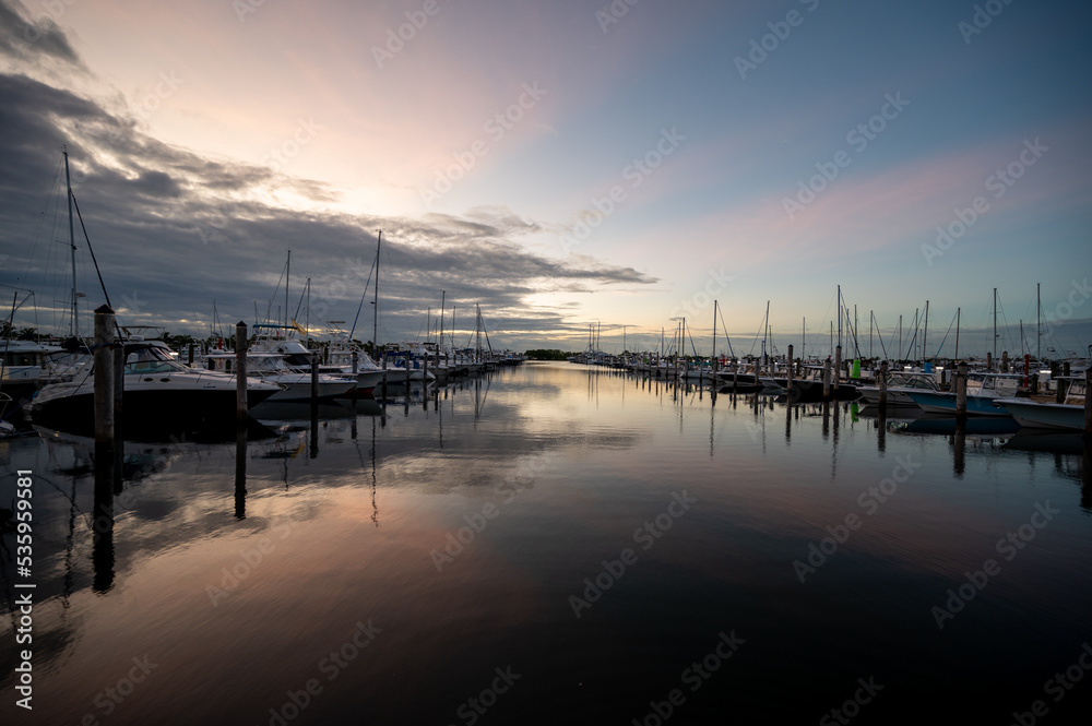 Boats docked at Dinner Key Marina in Coconut Grove, Miami, Florida in early morning light.