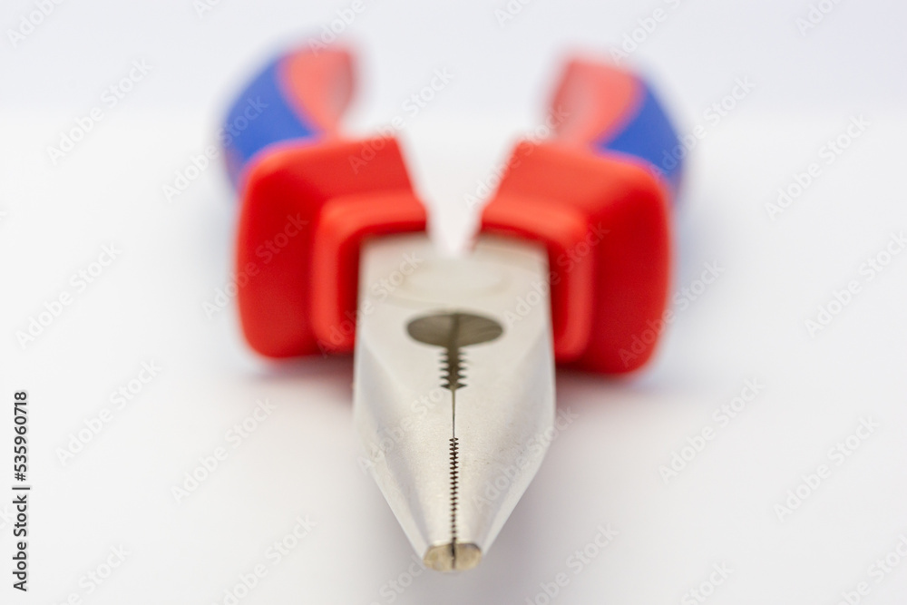 Hand tools, needle-nose pliers, red and blue on a white background. Hand tools, needle-nose pliers, red and blue on a white background.