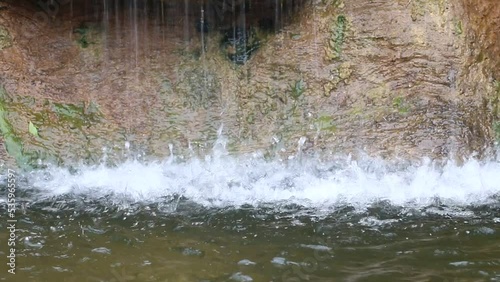 cold waterfall with stone background.