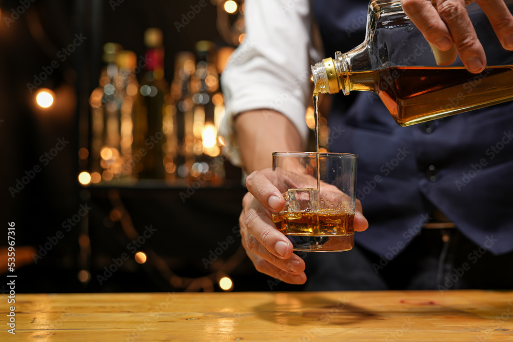 Bartender pouring Whiskey, on bar, Bartender pouring Whiskey, on bar,