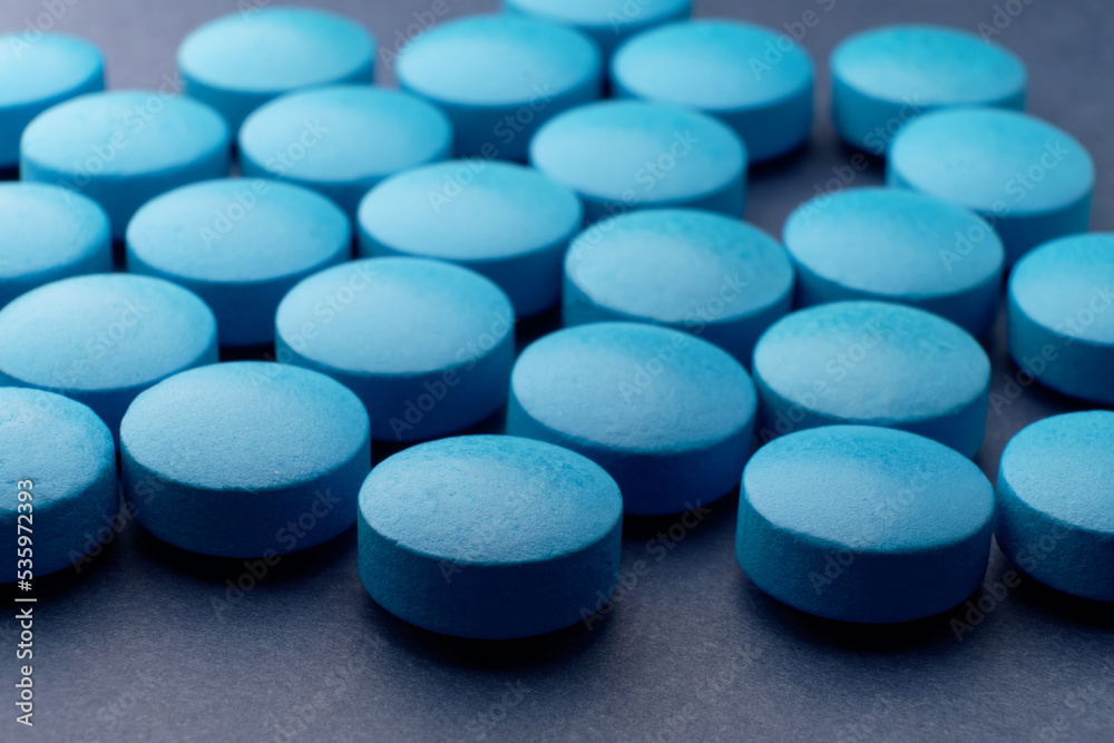 Blue pills tablets macro set on a blue background. It's for use in health  care and other fields where the color of the pill might be important Photos  | Adobe Stock