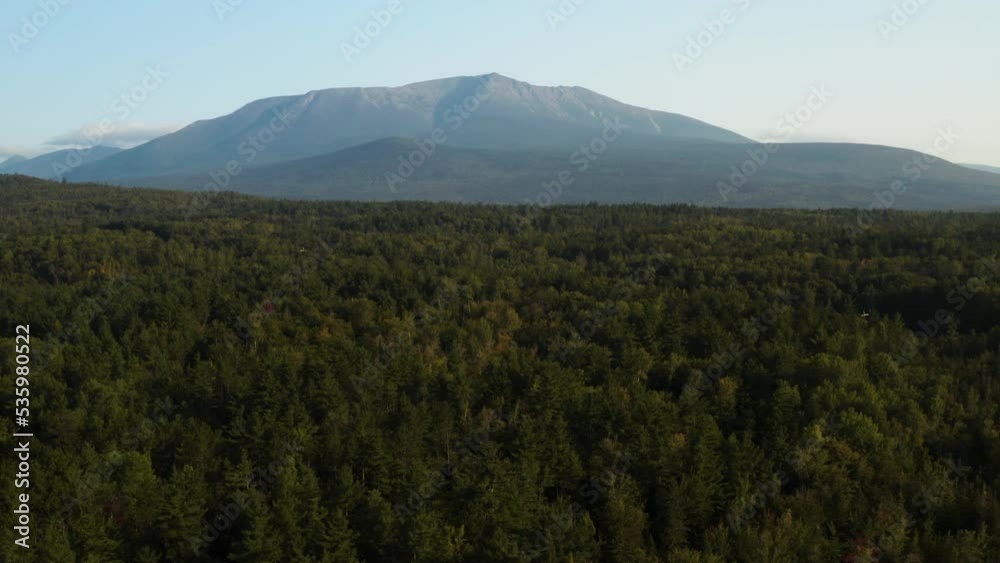 A drone flying over a large Maine forest with Mount Katahdin in the distance A drone flying over a large Maine forest with Mount Katahdin in the distance