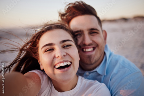 Couple, smile and beach together for selfie with happiness on face on holiday, honeymoon or vacation. Man, girl and happy at ocean on travel in summer in romantic photo for love, bonding and care © Siphosethu F/peopleimages.com