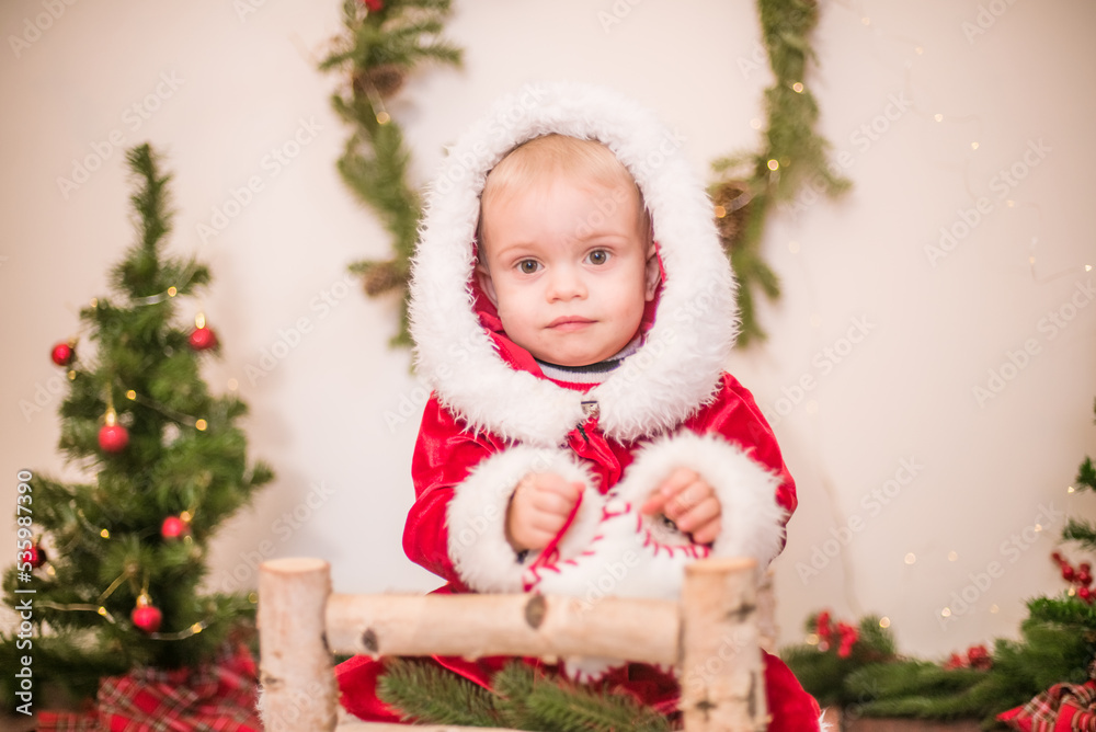 Little cute boy dressed as Santa Claus in a room decorated for Christmas. Christmas and children
Little cute boy dressed as Santa Claus in a room decorated for Christmas. Christmas and children