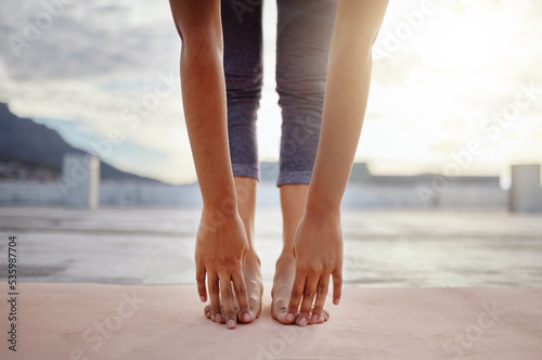 Stretching, feet and legs of woman in yoga meditation or outdoor exercise with morning sunshine lens flare. Sports, pilates or cardio person with workout training for zen, calm and healthy lifestyle
