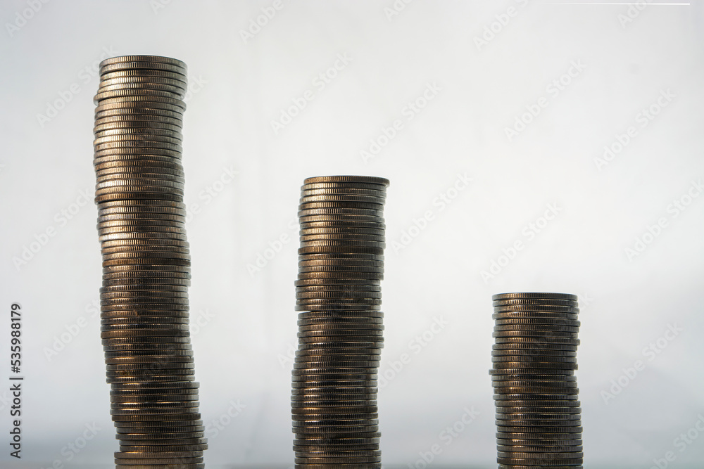 three stacks of coins, with the tallest stack on the left and the shortest on the right.