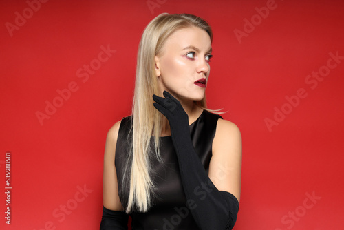 Concept of Halloween, young woman on red background