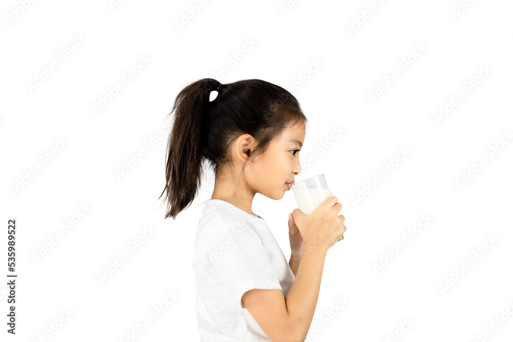 Side view of young Asian girl wear white t-shirt and drinking milk from a glass with clipping path. Side view of young Asian girl wear white t-shirt and drinking milk from a glass with clipping path.